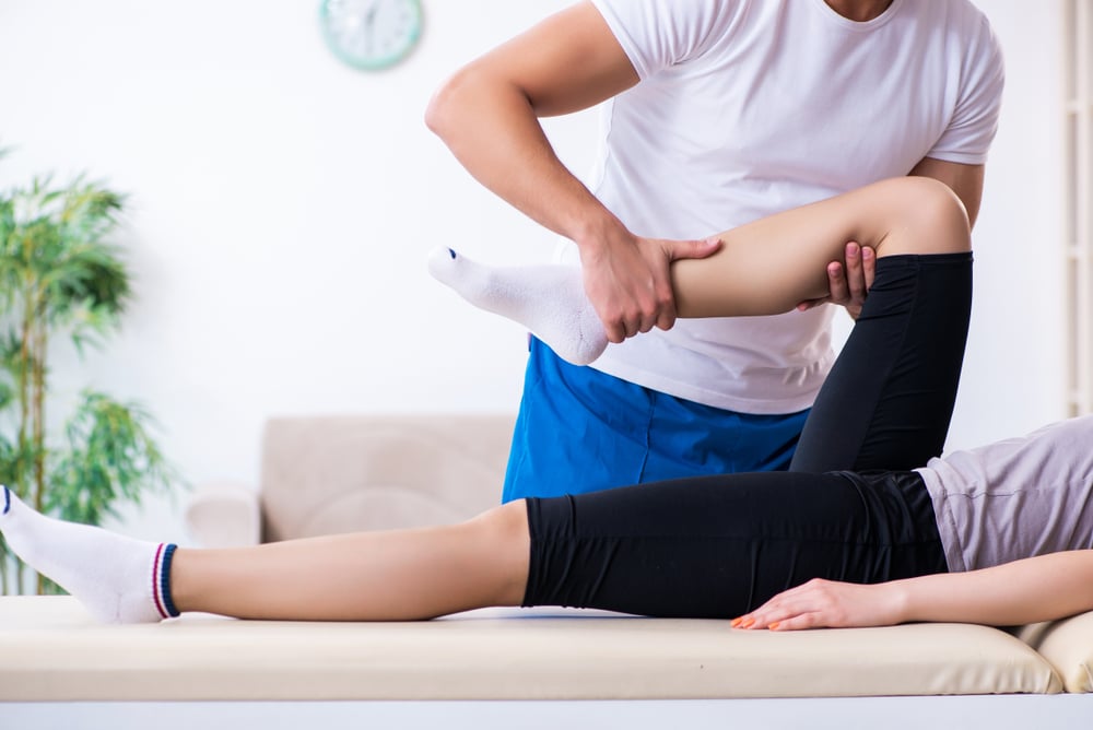Person in chiropractic or osteopathic consultation