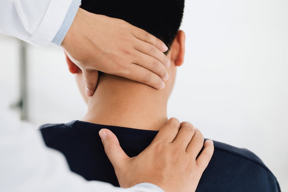 Osteopath or chiropractor treating patient with neck pain or headache