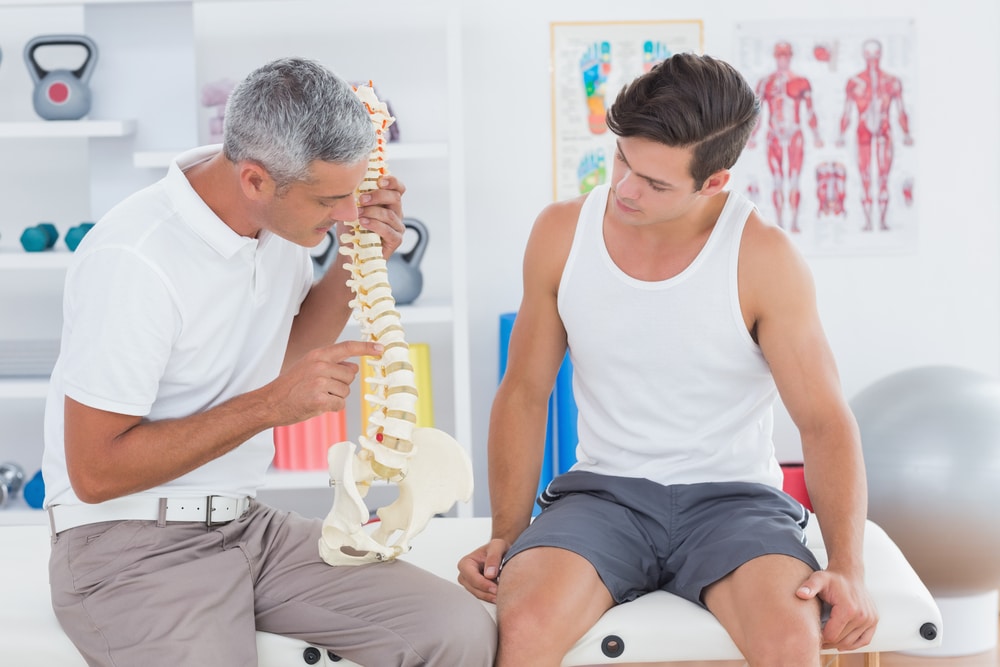 Osteopath discussing with patient