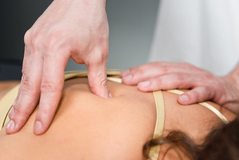 Woman receiving chiropractic treatment on back