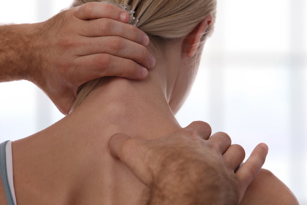Chiropractor treating woman's neck