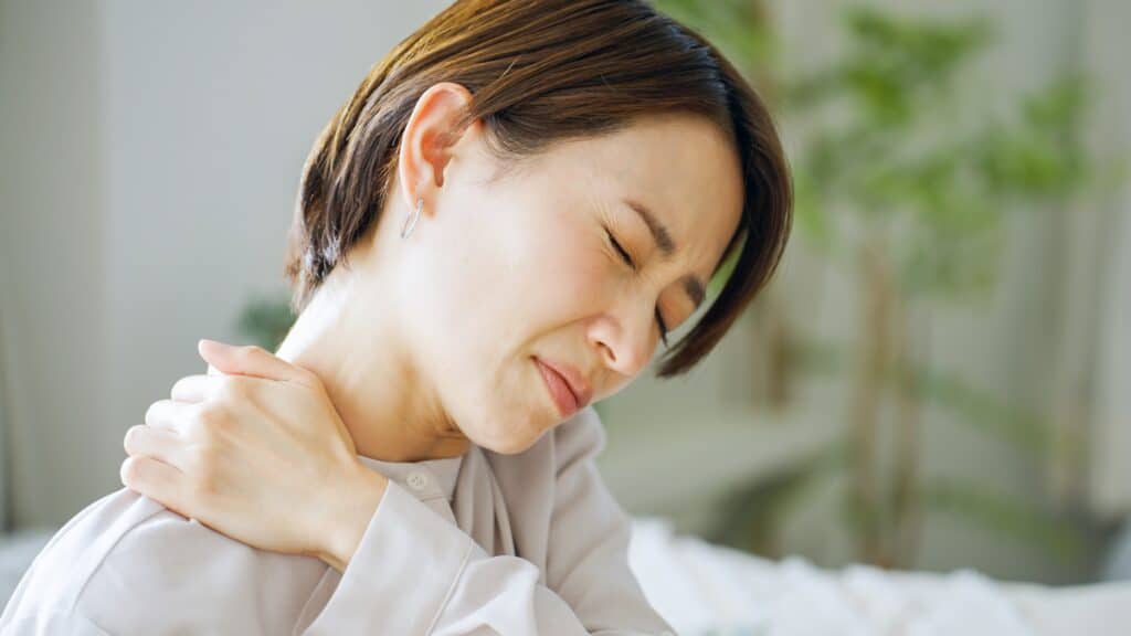 Person experiencing shoulder and neck pain